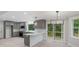 Gray kitchen boasts modern light fixtures, stainless steel appliances, and a sliding door to the deck at 136 Digh Cir # 4, Mooresville, NC 28117