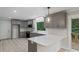 Well lit kitchen featuring stainless appliances, gray cabinets, light wood flooring, and white countertops at 136 Digh Cir # 4, Mooresville, NC 28117