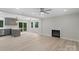 Bright living room featuring a fireplace, access to the deck, gray cabinets, and light wood flooring at 136 Digh Cir # 4, Mooresville, NC 28117