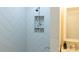 White shower with tiled walls and built-in shelving at 136 Digh Cir # 4, Mooresville, NC 28117