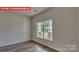 Bedroom featuring wood-look floors and a window overlooking the backyard at 1369 Secrest Commons Dr, Monroe, NC 28112
