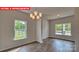 Bright dining room featuring stylish chandelier and views of the backyard at 1369 Secrest Commons Dr, Monroe, NC 28112