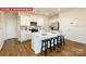 Stylish kitchen featuring a large center island, stainless steel appliances, white cabinetry, and hardwood floors at 1373 Zermatt Ct, Monroe, NC 28112