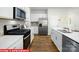 Close-up of kitchen showcasing stainless steel appliances, white cabinets, and a subway tile backsplash at 1373 Zermatt Ct, Monroe, NC 28112