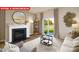 Cozy living room featuring a fireplace, modern decor, and a sliding glass door with view to the outdoors at 1373 Zermatt Ct, Monroe, NC 28112