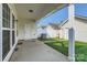 View of the backyard from a covered patio, with white fencing and detached garages at 13820 Cypress Woods Dr, Huntersville, NC 28078