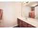 Bright bathroom with a single sink vanity and frameless mirror at 13820 Cypress Woods Dr, Huntersville, NC 28078