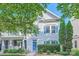 Charming two-story home with blue shutters and a manicured lawn at 13820 Cypress Woods Dr, Huntersville, NC 28078