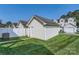 View of the detached garage from the backyard with partial fencing for added privacy at 13820 Cypress Woods Dr, Huntersville, NC 28078
