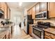 Functional kitchen with stainless steel appliances and wooden cabinets at 13820 Cypress Woods Dr, Huntersville, NC 28078