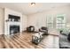 Spacious living room with a fireplace, hardwood floors, and neutral decor at 13820 Cypress Woods Dr, Huntersville, NC 28078