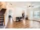 Open living area featuring hardwood floors, a ceiling fan, and large windows at 13820 Cypress Woods Dr, Huntersville, NC 28078