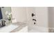 Bright bathroom features a gray countertop, white sink and toilet, and updated hardware at 1802 Cooper Ave, Kannapolis, NC 28081
