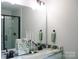 Modern bathroom featuring a double vanity with marble countertop and a sleek glass-enclosed shower at 1802 Cooper Ave, Kannapolis, NC 28081