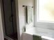 Clean bathroom featuring a white tub with green towels, next to a glass-enclosed shower at 1802 Cooper Ave, Kannapolis, NC 28081