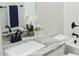 Updated bathroom with gray marble countertop, black fixtures, and a white orchid at 1802 Cooper Ave, Kannapolis, NC 28081