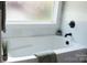 Bright bathtub with window, featuring marble surround and modern fixtures at 1802 Cooper Ave, Kannapolis, NC 28081