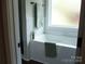 Bright bathroom featuring a white tub with marble tile surround, accented by green towels at 1802 Cooper Ave, Kannapolis, NC 28081