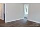 Bright bedroom showing hardwood floors and view to the en-suite bathroom at 1802 Cooper Ave, Kannapolis, NC 28081