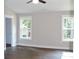 Bright bedroom with hardwood floors and two windows providing natural light at 1802 Cooper Ave, Kannapolis, NC 28081