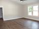 Spacious bedroom with wood flooring, a window, and a ceiling fan at 1802 Cooper Ave, Kannapolis, NC 28081