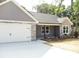 Charming home with stone and gray siding, complemented by a driveway and a two-car garage at 1802 Cooper Ave, Kannapolis, NC 28081