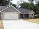Beautiful single-story home featuring stone accents, gray siding, and a convenient attached garage at 1802 Cooper Ave, Kannapolis, NC 28081