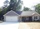 Inviting single-story home boasts a gray exterior, stone details, and a convenient two-car garage at 1802 Cooper Ave, Kannapolis, NC 28081