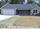 Attractive single-story home with a two-car garage, stone accents, and manicured front yard at 1802 Cooper Ave, Kannapolis, NC 28081