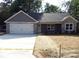 Attractive single-story home showing gray exterior, stone accents, and a two-car garage at 1802 Cooper Ave, Kannapolis, NC 28081