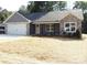 Charming single-story home featuring a gray exterior, stone accents, and a two-car garage in a suburban setting at 1802 Cooper Ave, Kannapolis, NC 28081
