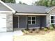 The home features fresh landscaping, stone accents, and a covered porch at 1802 Cooper Ave, Kannapolis, NC 28081