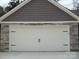 Close-up of the garage door with stone and shake accents, showing classic curb appeal details at 1802 Cooper Ave, Kannapolis, NC 28081