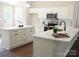 Modern kitchen featuring white cabinetry, marble countertops, stainless steel appliances, and a central island at 1802 Cooper Ave, Kannapolis, NC 28081