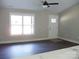 Bright living room featuring wood flooring, a white door, and a window providing natural light at 1802 Cooper Ave, Kannapolis, NC 28081