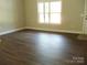 Bright living room with hardwood floors and natural light from a large window at 1802 Cooper Ave, Kannapolis, NC 28081
