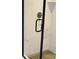 Updated shower featuring a glass door, modern fixtures, and patterned tile flooring at 1802 Cooper Ave, Kannapolis, NC 28081