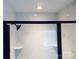 A modern shower with a dark metal frame, white tiles with gray marbling, and green honeycomb floor at 1802 Cooper Ave, Kannapolis, NC 28081