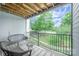 Relax on this inviting balcony featuring a swing bench and furniture overlooking lush green scenery at 18741 Nautical Dr # 205, Cornelius, NC 28031