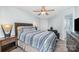 Bedroom with a hard surface floor, a nightstand on either side of the bed, and a door at 18741 Nautical Dr # 205, Cornelius, NC 28031
