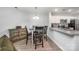 Charming dining area featuring modern lighting, a dark wood table, and a glimpse into the kitchen at 18741 Nautical Dr # 205, Cornelius, NC 28031
