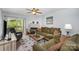Comfortable living room with fireplace, plush seating, stylish rug, and sliding door to balcony at 18741 Nautical Dr # 205, Cornelius, NC 28031