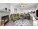 Open-concept living room with fireplace, plush seating, stylish rug and view into dining area at 18741 Nautical Dr # 205, Cornelius, NC 28031