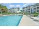 Community swimming pool with sun loungers surrounded by manicured lawns and residential buildings at 18741 Nautical Dr # 205, Cornelius, NC 28031