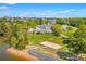 Aerial shot of community amenities including a clubhouse, pool, sand volleyball court, and waterfront access at 2004 Marquesas Ave, Tega Cay, SC 29708
