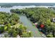 Aerial view showing home, dock, and Lake Wylie, nestled amongst a grove of mature trees at 2004 Marquesas Ave, Tega Cay, SC 29708