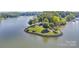 Aerial view of peninsula featuring lush green lawn, mature trees, and lakeside access at 2004 Marquesas Ave, Tega Cay, SC 29708