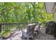Relaxing back deck featuring comfortable outdoor chairs, a small side table, and a grill at 2004 Marquesas Ave, Tega Cay, SC 29708