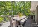 Inviting back deck with outdoor dining table, bench seating, and lush green tree views at 2004 Marquesas Ave, Tega Cay, SC 29708