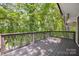 Spacious deck with dark wood flooring and railing, and a serene view of the lush forest and river at 2004 Marquesas Ave, Tega Cay, SC 29708